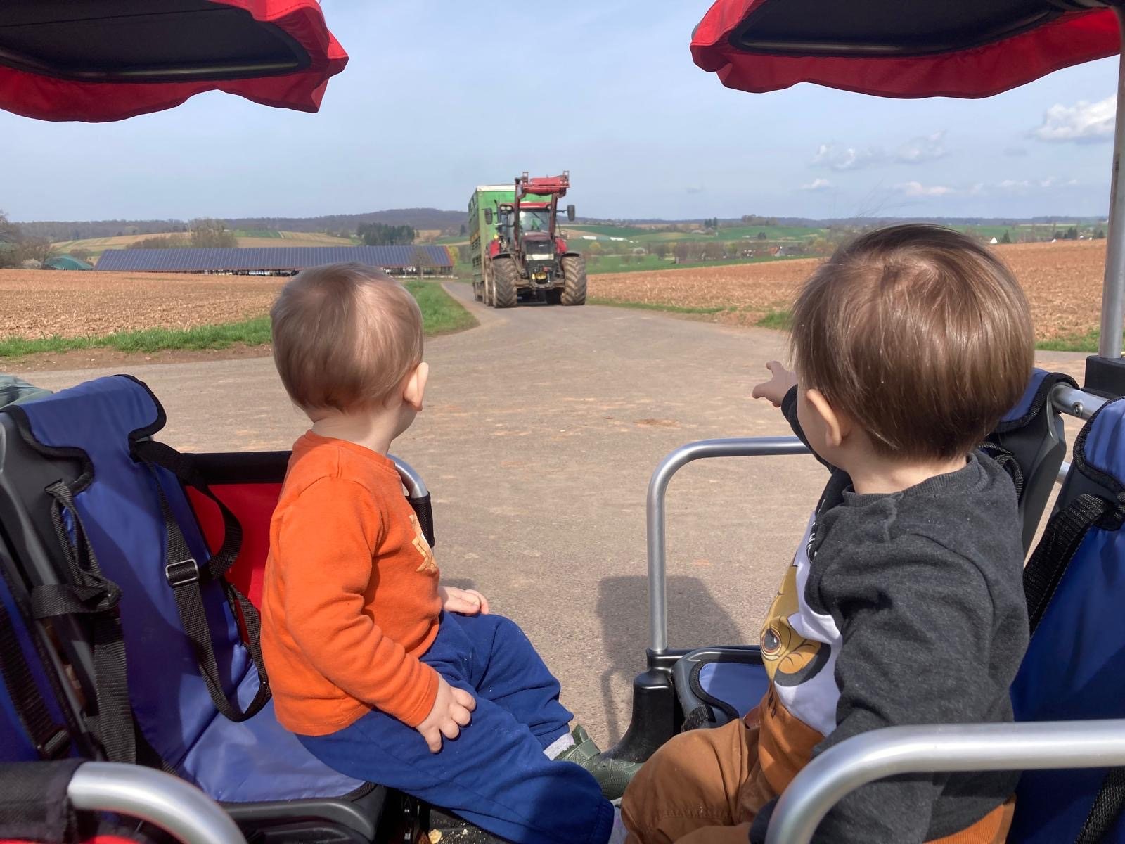 Kinder beobachten einen Traktor